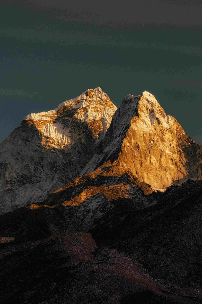 Everest (1) Golden sunset light bathes the majestic peaks of the Himalayas, creating a stunning natural spectacle. sunrise view of everest base camp makes it golden color more beautiful.