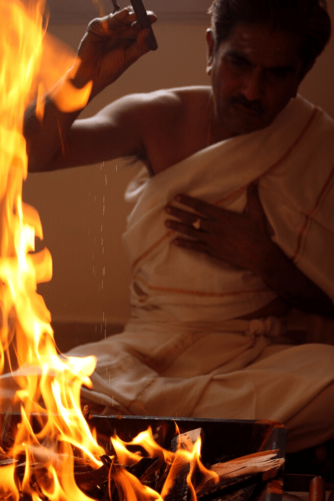 fire offering A Hindu priest performing a homa (fire sacrifice) in the orthodox Tantric tradition. Such fire rituals in Dakshinachara Tantra use clarified butter and herbs as offerings to Divine Fire (Agni), aligning with Vedic purity and serving as a meditative, purifying practice.