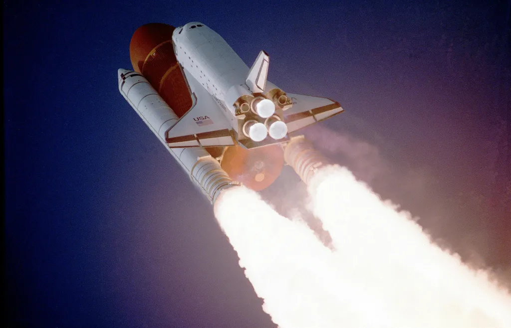 flight-sky-earth-space-2159 A space shuttle launches into space, showcasing powerful rocket engines and USA branding.