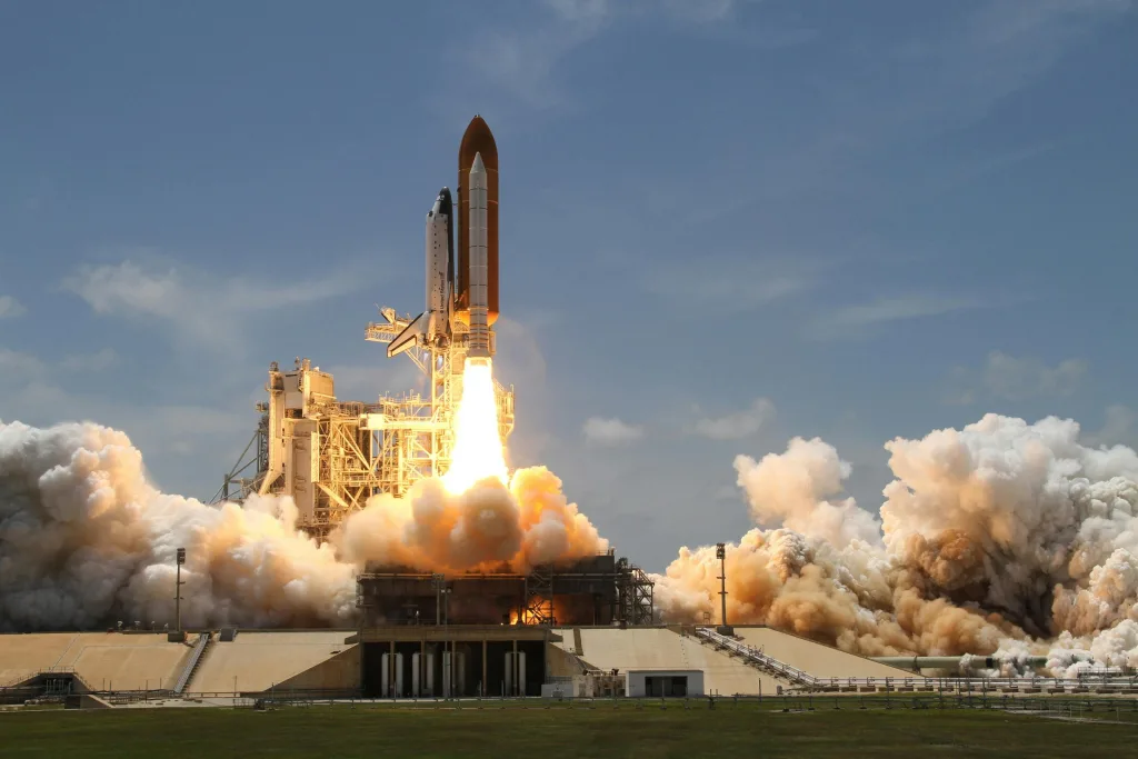 flight-sky-earth-space A NASA space shuttle launches with fiery liftoff, ascending into the sky amid plumes of smoke. where two astronauts Barry Wilmore and Suni Williams are inside.