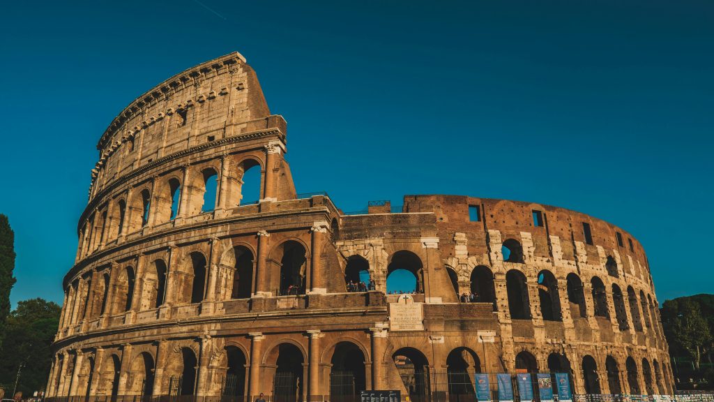 Rome Stunning view of the ancient Roman Colosseum in Rome, Italy, captured at sunset showcasing its historic arches.