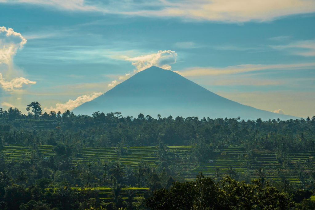 Bali Stunning view of a volcano amidst lush greenery in Lampung, Indonesia. Perfect for nature lovers.