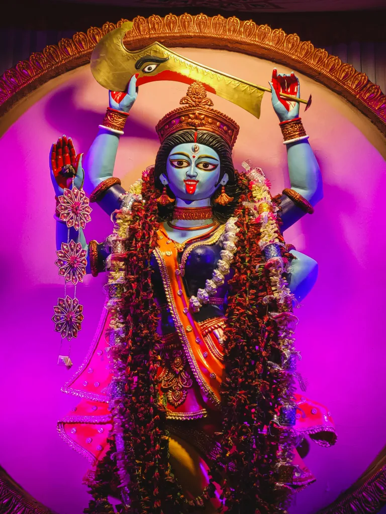 Kalika Colorful statue of Goddess Kalika adorned with garlands in a Kolkata temple.