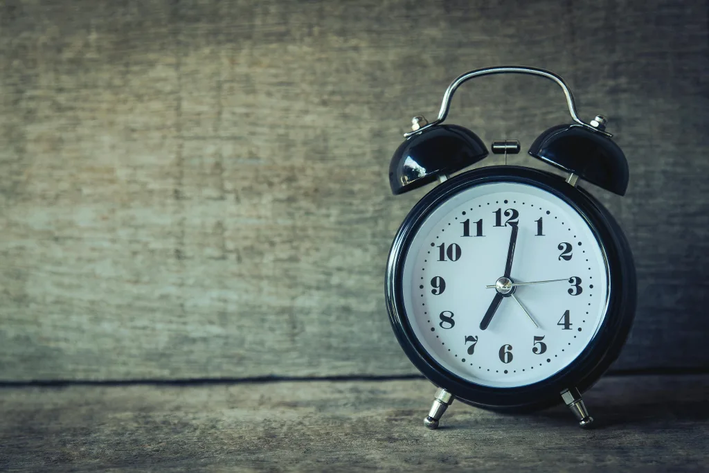 clock Classic black analog alarm clock on rustic wooden background, perfect for time and nostalgia themes.clock quotes