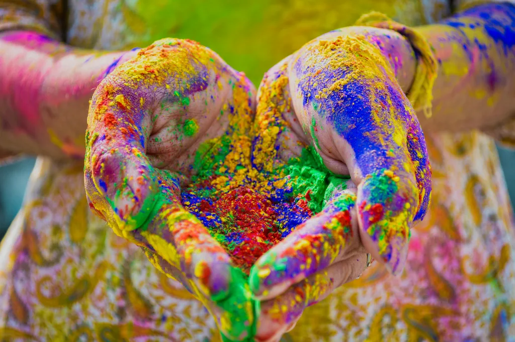 pexels-photo-3906333-3906333 Close-up of colorful hands holding vivid Holi festival powder showcasing vibrant celebration.