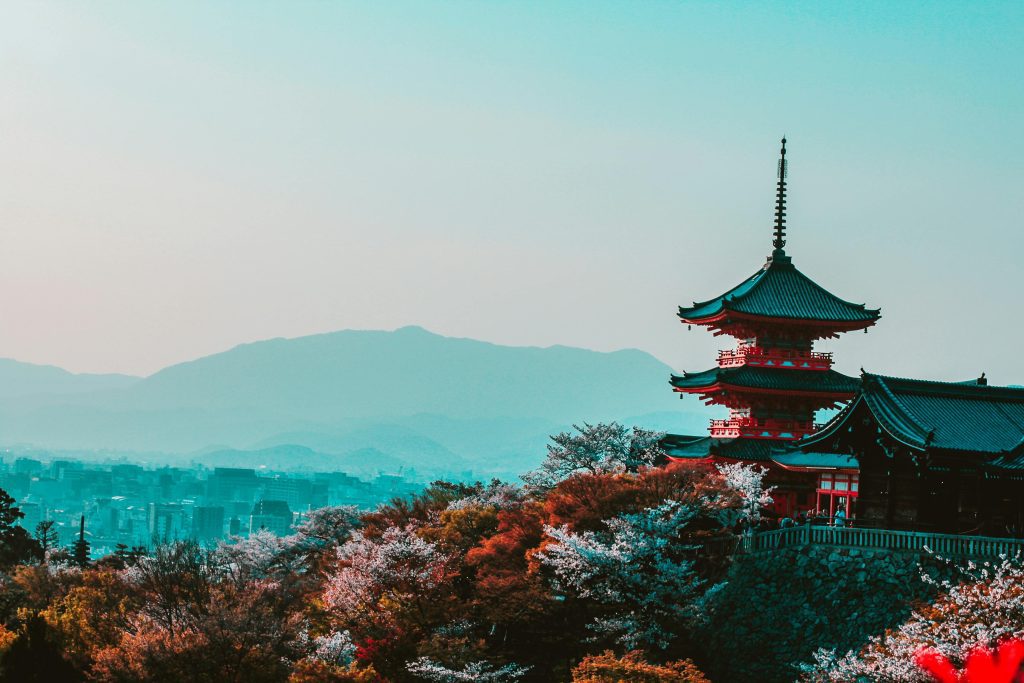 Japan Scenic view of Kiyomizu-dera Temple with cherry blossoms in Kyoto, Japan, capturing traditional Japanese architecture at twilight.