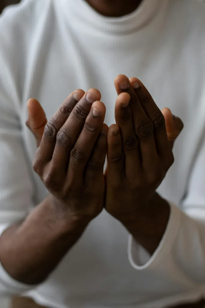 quotes Selective focus of crop anonymous African American man wearing white turtleneck praying with open hands beflief quotes