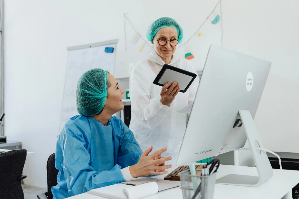 pexels-photo-8539424-8539424 Two female medical researchers discussing a project using a tablet in a laboratory setting.