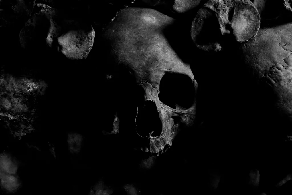 pexels-photo-970517-970517 Dark eerie skull image with a moody atmosphere from the Paris Catacombs.