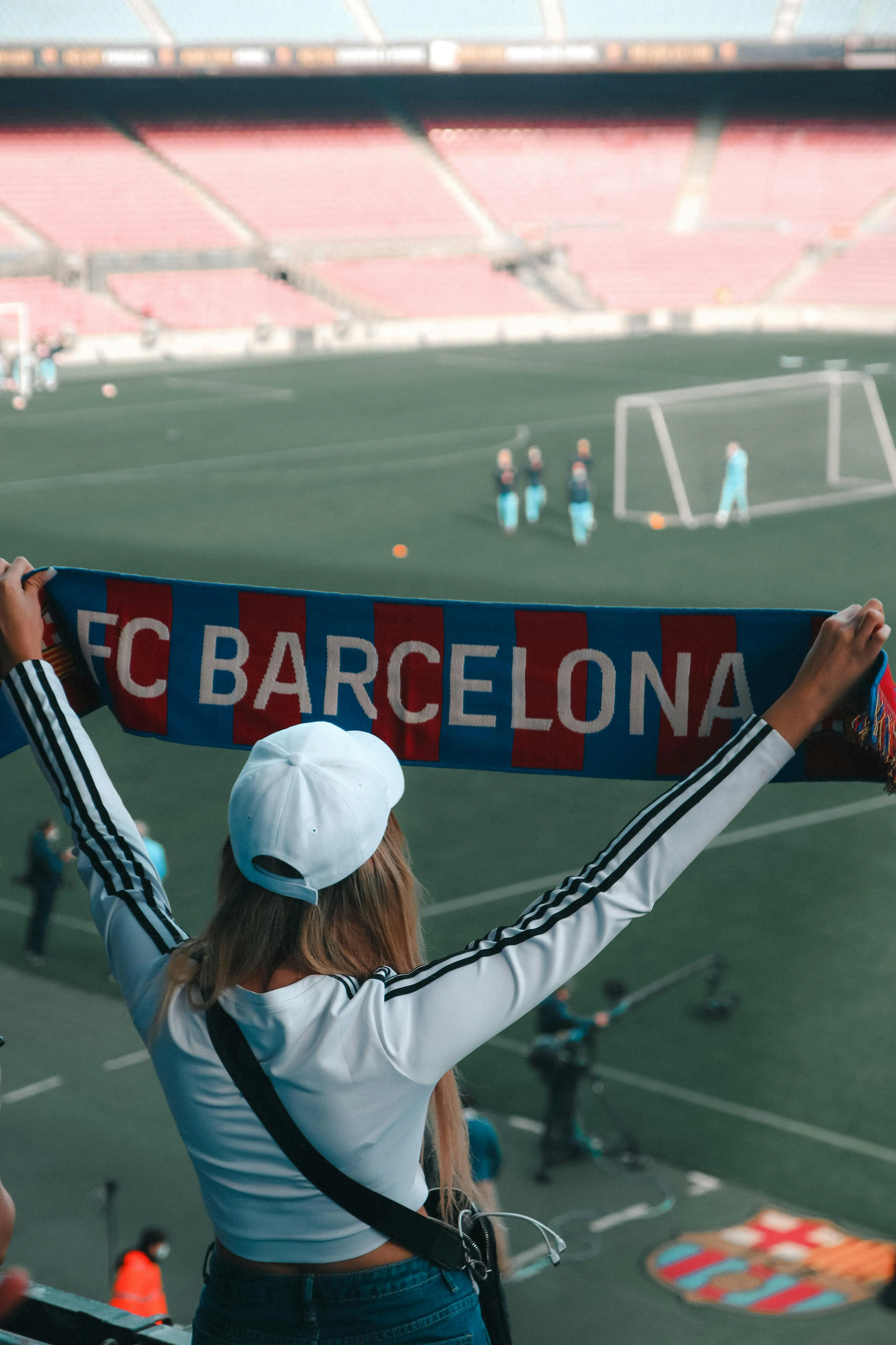 Excited FC Barcelona fan holding a team scarf at the stadium, enjoying a FIFA Club World Cup