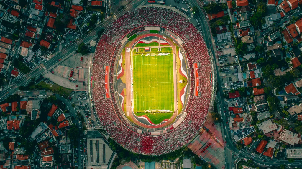 pexels-photo-31331114-31331114 Vibrant aerial shot of a packed football stadium with panoramic cityscape.