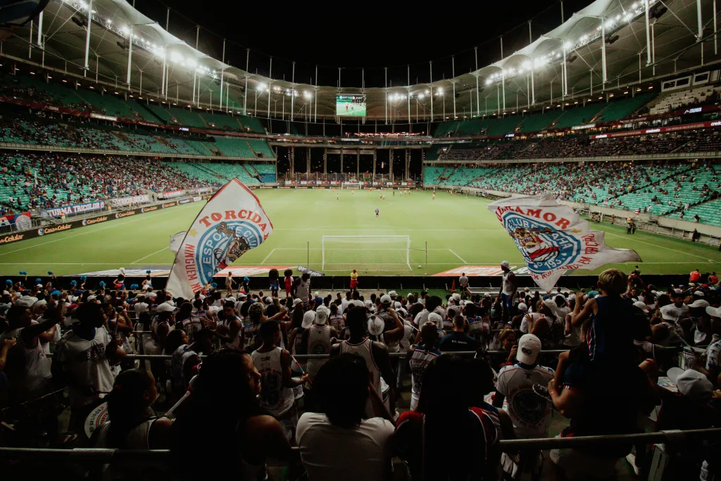 pexels-photo-31377598-31377598 Energetic soccer fans cheer during a night match at a large stadium, creating an exciting atmosphere.