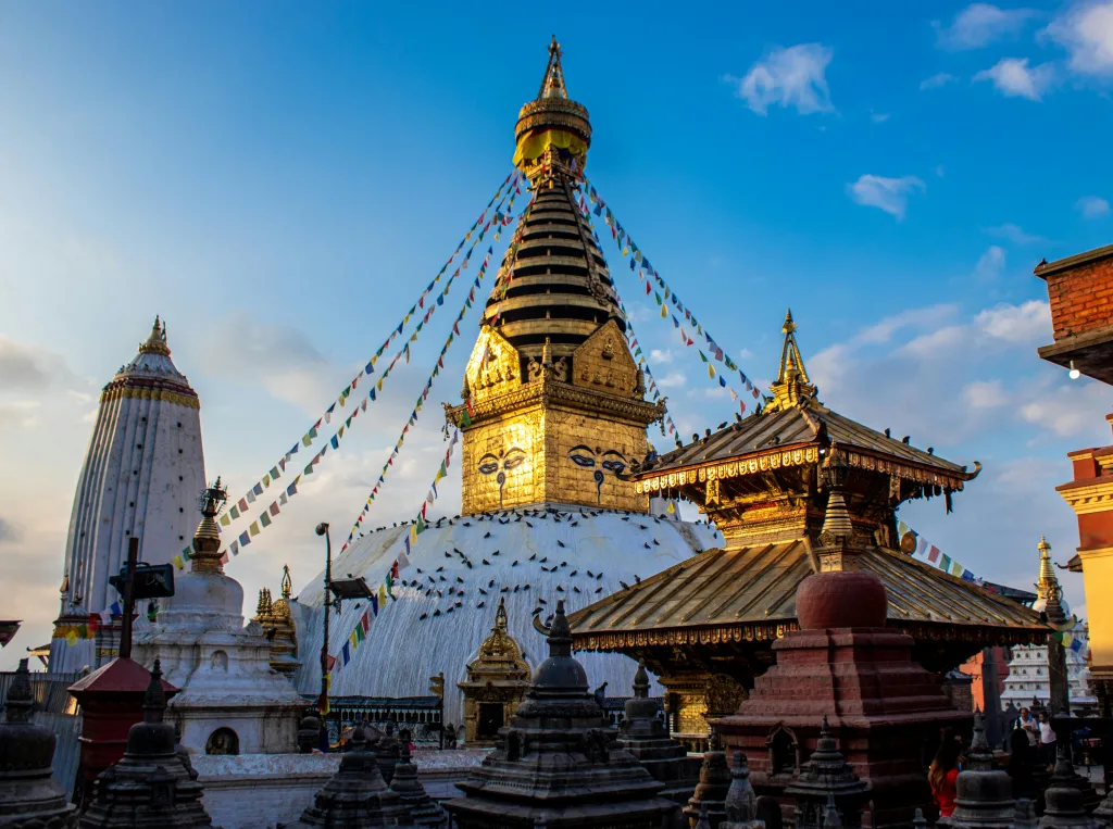 Swayambhunath Stupa Captivating photo of the iconic Swayambhunath Stupa under a clear blue sky in Kathmandu, Nepal.