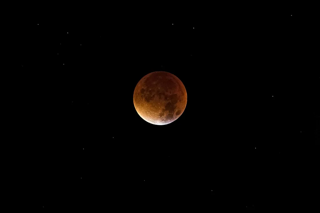 mars Beautiful image of a lunar eclipse, showcasing the moon's dramatic red hue against a starry sky.